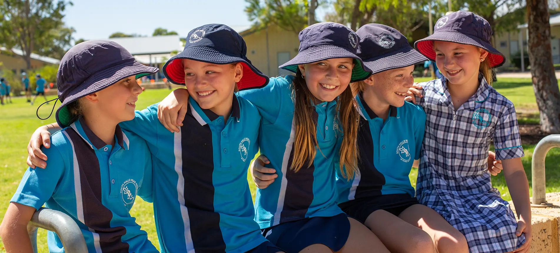 A group of South Halls Head students together in school uniform and hats