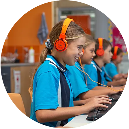 South Halls Head students learning at computers wearing headphones